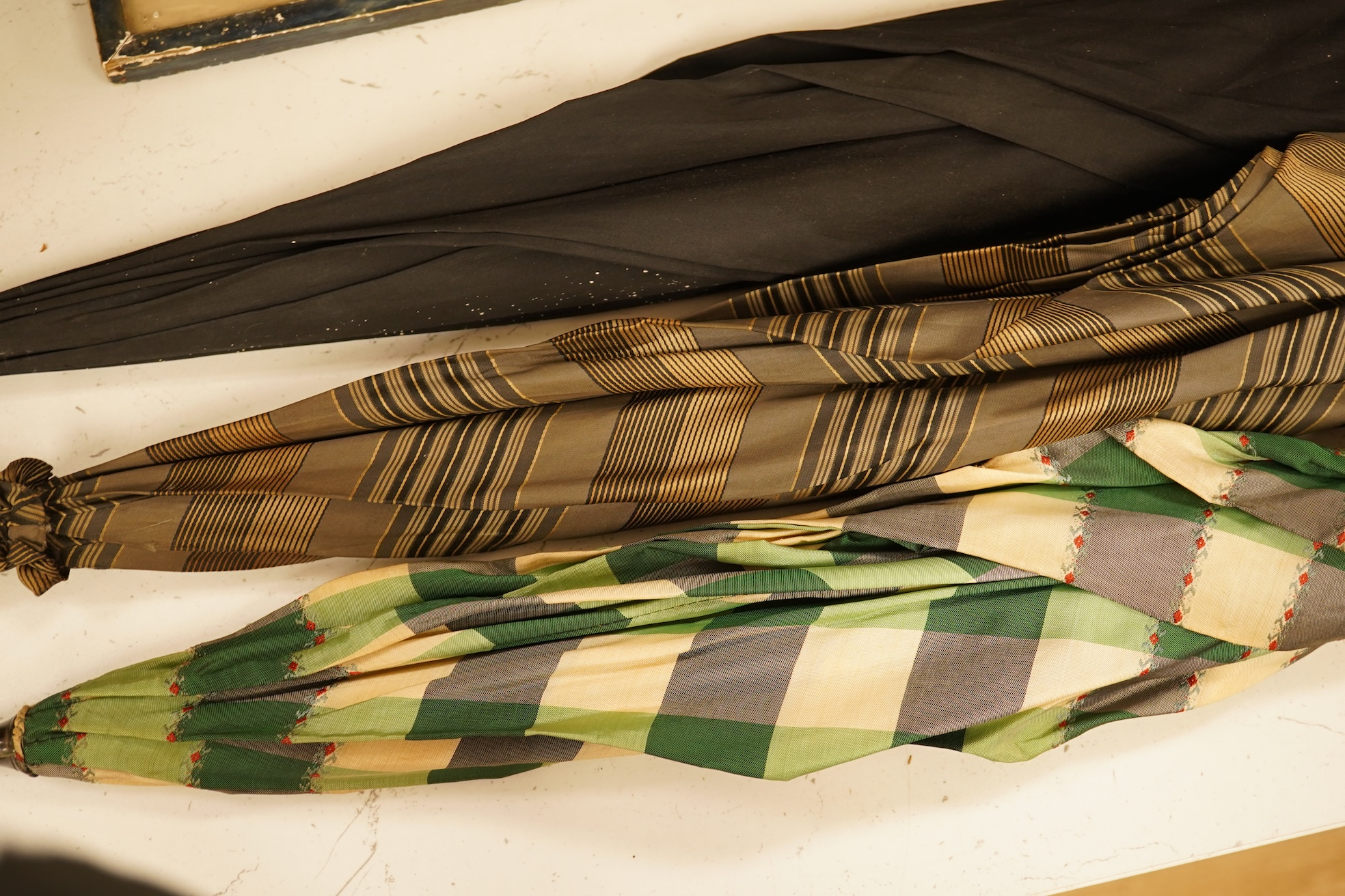 An early 20th century gold mounted Brigg of London silk parasol and two others